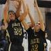 Dexter senior Jay Lewis and sophomore Derek Sieidl reach for a rebound in the second half against Pioneer during a district match up at Pioneer on Wednesday. Melanie Maxwell I AnnArbor.com